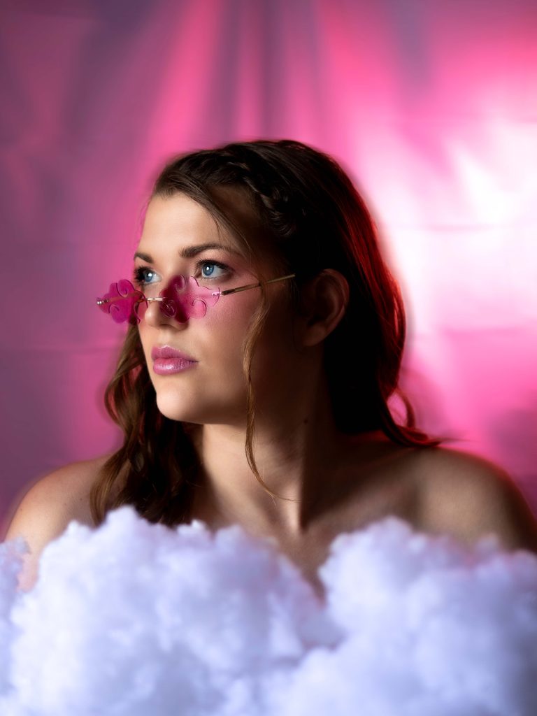 A portrait in the series of elements. Every pair of glasses inspired me to do a different element. Thepink one, air. Up in the pink clouds