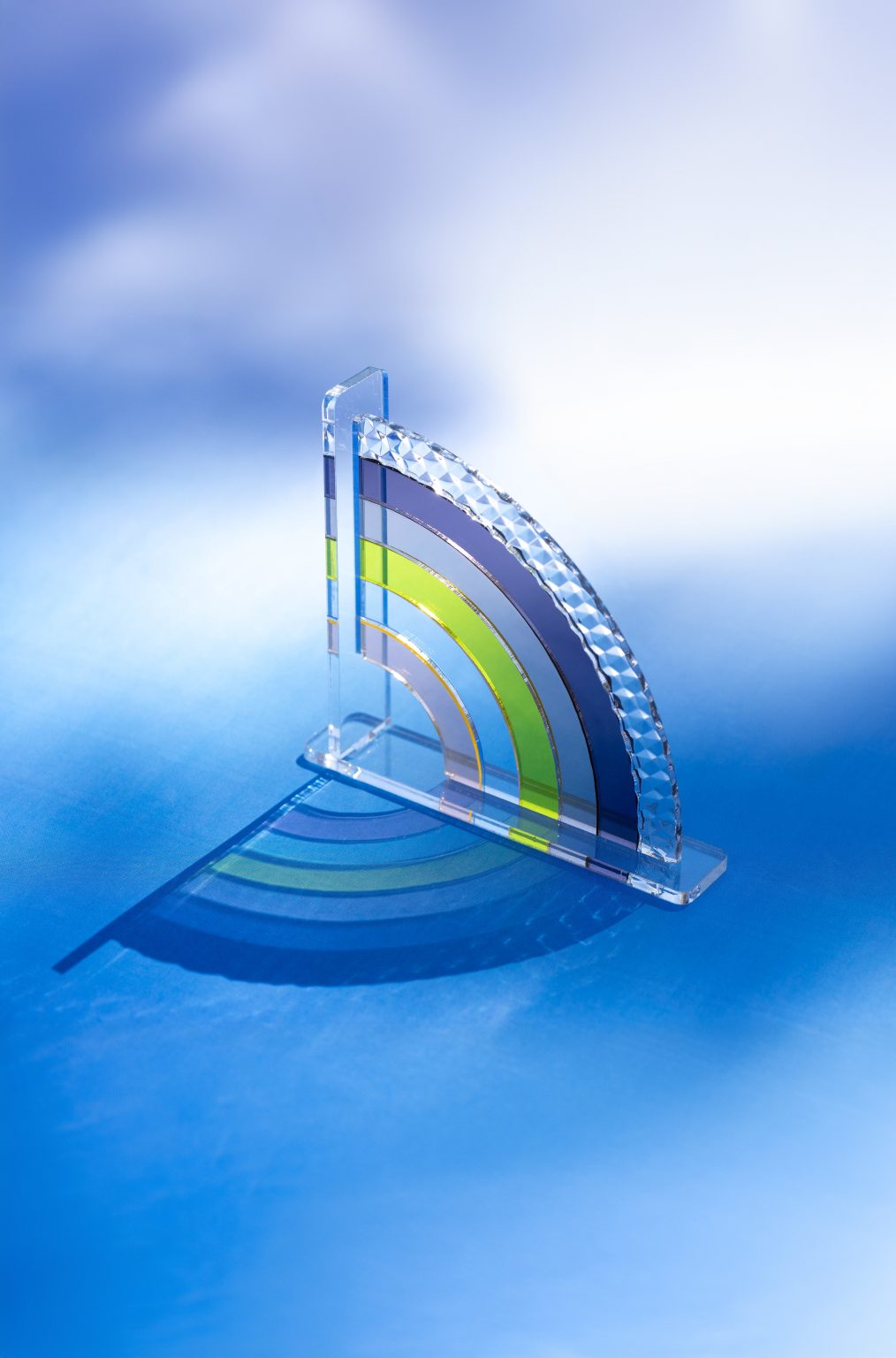 A Rainbow with a reflection and a gradient background from purple to blue.