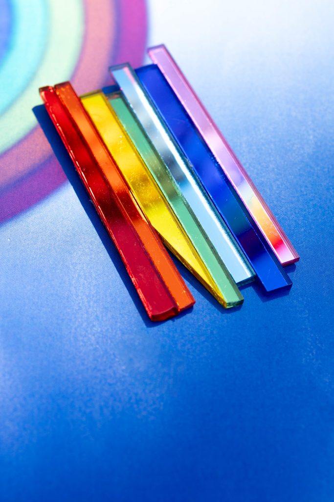 Momantai Rainbow Magnet, with a white / blue gradient background and a reflection of the rainbow. photo by mandy liebregts